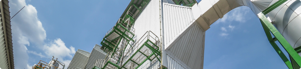 A panoramic view from below, capturing the towering presence of modern buildings against a blue sky, with visible scaffolding and construction elements.